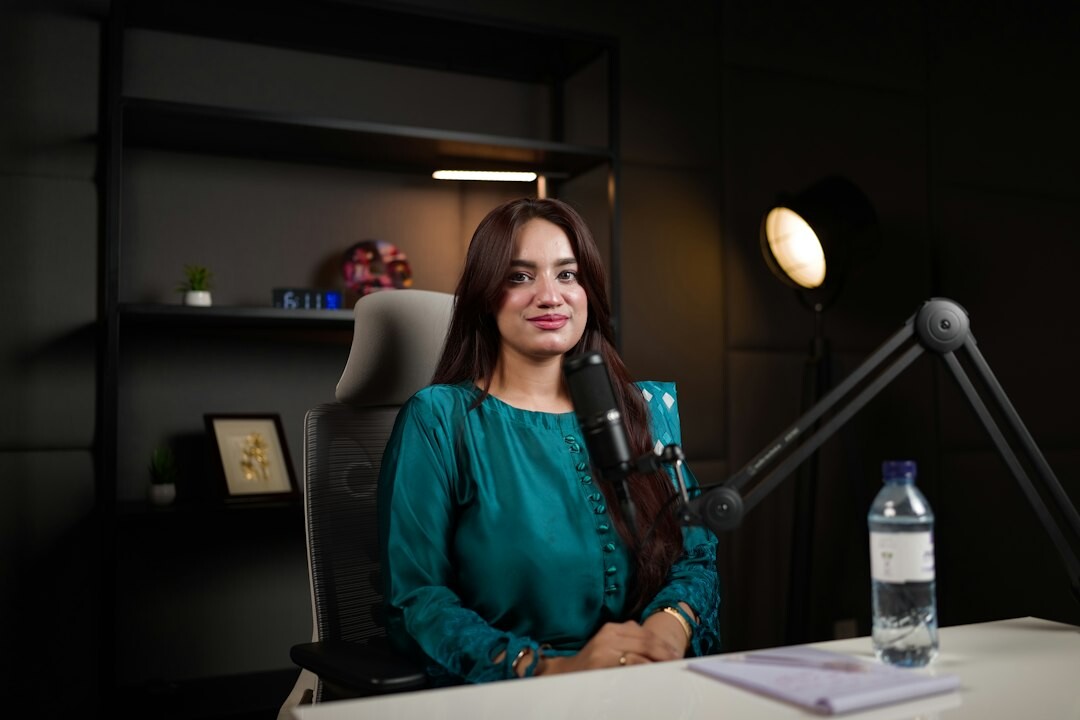 Journalist interviewing a guest in a professional broadcast studio with microphones